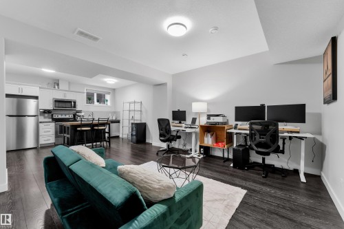 Home office featuring dark wood-style floors and baseboards - 906 Berg Place, Leduc, AB - Indoor