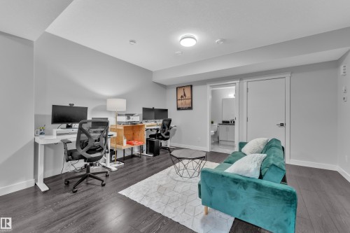 Office featuring baseboards and wood finished floors - 906 Berg Place, Leduc, AB - Indoor