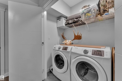 Laundry area featuring separate washer and dryer and baseboards - 906 Berg Place, Leduc, AB - Indoor Photo Showing Laundry Room