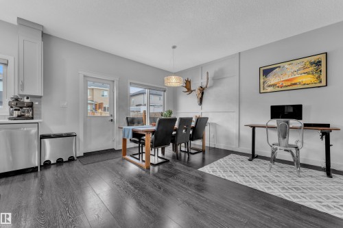 Dining space with dark wood-type flooring and a textured ceiling - 906 Berg Place, Leduc, AB - Indoor