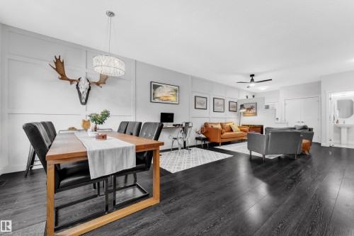 Dining area with a decorative wall, dark wood-style flooring, a ceiling fan, and suspended lighting - 906 Berg Place, Leduc, AB - Indoor