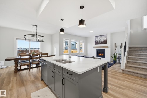 54 Willow Link, Fort Saskatchewan, AB - Indoor Photo Showing Kitchen With Fireplace With Double Sink