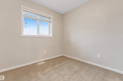 Carpeted empty room featuring baseboards - 