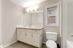 Full bathroom with vanity and light tile patterned floors - 