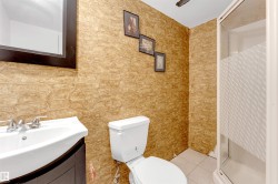 Full bath with a stall shower, vanity, and light tile patterned floors - 