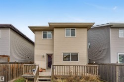 Back of property featuring a fenced backyard and a wooden deck - 