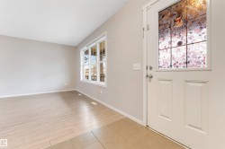 Entrance foyer with baseboards and light tile patterned flooring - 