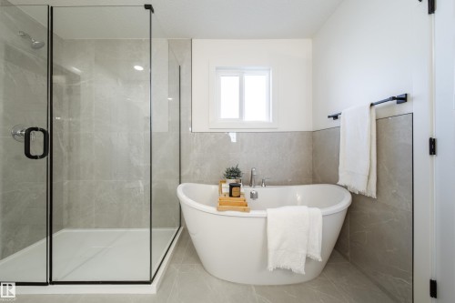 Bathroom featuring tile walls, a soaking tub, and a shower stall - 34 Sun Meadows Cl, Stony Plain, AB - Indoor Photo Showing Bathroom