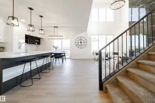 Stairway featuring hanging lights, wood finished floors, and a high ceiling - 34 Sun Meadows Cl, Stony Plain, AB - Indoor