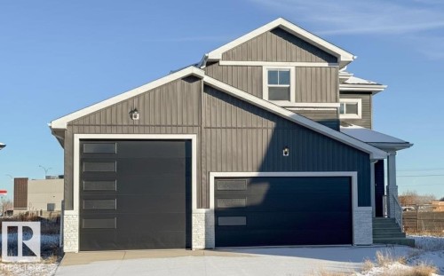 View of front of home with a garage and stone siding - 34 Sun Meadows Cl, Stony Plain, AB - Outdoor
