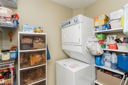 Laundry area featuring stacked washer / dryer and a textured ceiling - 