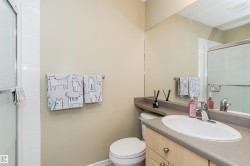 Bathroom featuring a shower stall and vanity - 