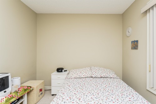 Bedroom with light carpet and a textured ceiling - 314 4403 23 Street, Edmonton, AB - Indoor Photo Showing Bedroom