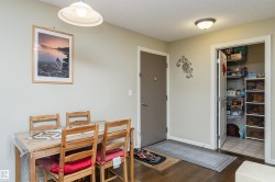 Dining area featuring a textured ceiling and dark wood-style flooring - 