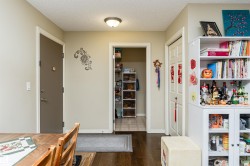 Dining area with a textured ceiling and dark wood-style flooring - 