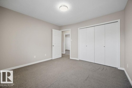 Unfurnished bedroom with carpet floors, a closet, and a textured ceiling - 736 Johns Road, Edmonton, AB - Indoor Photo Showing Other Room