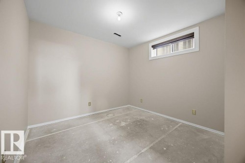 Empty room featuring baseboards and unfinished concrete flooring - 736 Johns Road, Edmonton, AB - Indoor Photo Showing Other Room