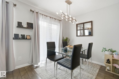Dining area with wood-type flooring and hanging lights - 64 2004 Grantham Court, Edmonton, AB - Indoor Photo Showing Dining Room