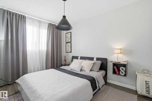 Bedroom featuring wood finished floors and baseboards - 64 2004 Grantham Court, Edmonton, AB - Indoor Photo Showing Bedroom