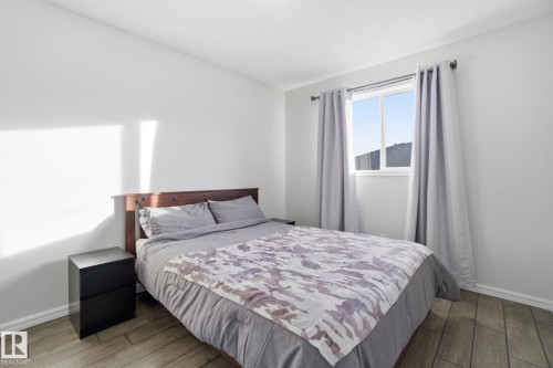 Bedroom with baseboards and wood finished floors - 64 2004 Grantham Court, Edmonton, AB - Indoor Photo Showing Bedroom