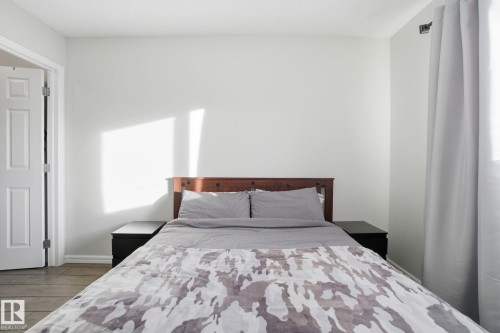 Bedroom with wood finished floors and baseboards - 64 2004 Grantham Court, Edmonton, AB - Indoor Photo Showing Bedroom