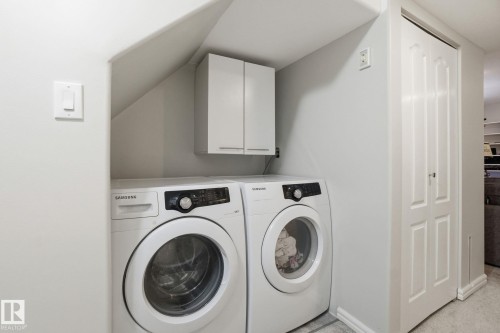 Laundry area with washing machine and clothes dryer and cabinet space - 64 2004 Grantham Court, Edmonton, AB - Indoor Photo Showing Laundry Room