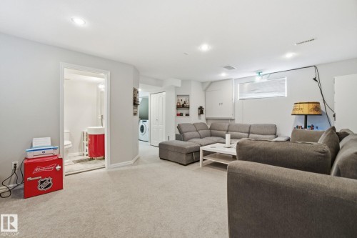 Living room with carpet floors, recessed lighting, and washer / clothes dryer - 64 2004 Grantham Court, Edmonton, AB - Indoor Photo Showing Living Room