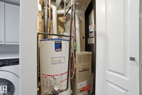 Utilities with water heater and washer / clothes dryer - 64 2004 Grantham Court, Edmonton, AB - Indoor Photo Showing Basement