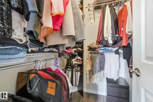 Walk in closet featuring dark wood-type flooring - 64 2004 Grantham Court, Edmonton, AB - Indoor With Storage
