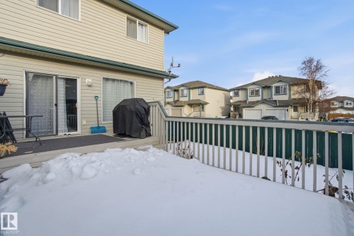 Snowy yard with a residential view and a deck - 64 2004 Grantham Court, Edmonton, AB - Outdoor With Deck Patio Veranda With Exterior