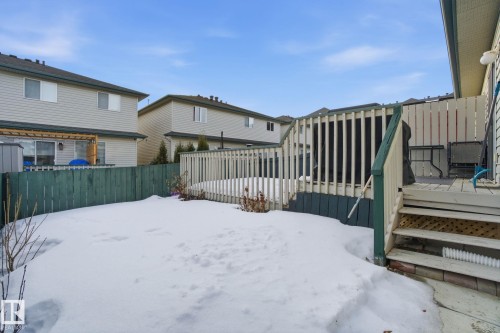 Yard covered in snow featuring a wooden deck - 64 2004 Grantham Court, Edmonton, AB - Outdoor With Deck Patio Veranda With Exterior