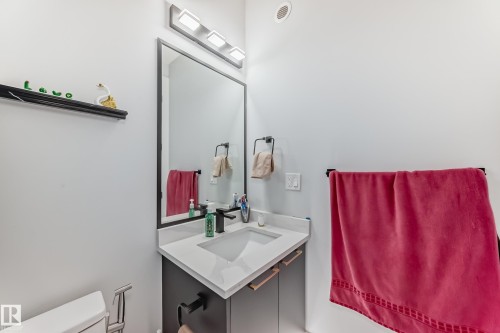 Half bathroom featuring vanity and toilet - 17112 68 Street, Edmonton, AB - Indoor Photo Showing Bathroom