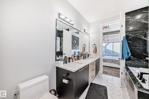 Bathroom featuring a garden tub, double vanity, light tile patterned floors, and connected bathroom - 17112 68 Street, Edmonton, AB - Indoor Photo Showing Bathroom