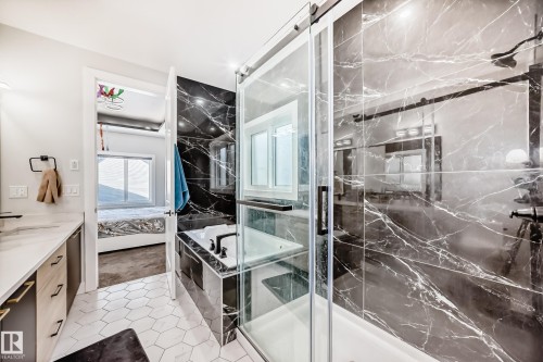 Ensuite bathroom featuring a garden tub, vanity, a marble finish shower, light tile patterned floors, and light carpet - 17112 68 Street, Edmonton, AB - Indoor Photo Showing Bathroom