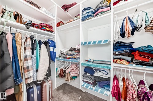 Walk in closet featuring dark colored carpet - 17112 68 Street, Edmonton, AB - Indoor With Storage