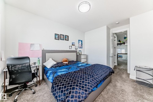 Bedroom featuring light colored carpet and a desk - 17112 68 Street, Edmonton, AB - Indoor Photo Showing Bedroom