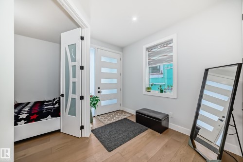 Entryway with light wood-style floors and baseboards - 17112 68 Street, Edmonton, AB - Indoor Photo Showing Other Room