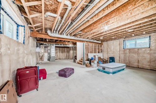 Basement with heating unit and stairway - 17112 68 Street, Edmonton, AB - Indoor Photo Showing Basement