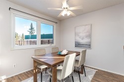 Dining room featuring wood finished floors, a textured ceiling, and ceiling fan - 