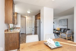 Dining room with dark wood-type flooring and a textured ceiling - 