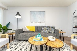 Living room featuring a textured ceiling and wood finished floors - 
