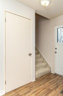 Foyer with stairway, a textured ceiling, and light wood-type flooring - 
