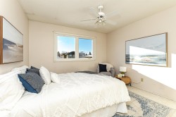 Bedroom featuring a textured ceiling, ceiling fan, and carpet floors - 