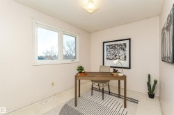 Office area with a textured ceiling and carpet floors - 