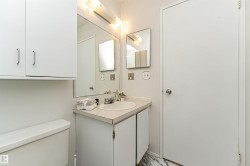 Half bath featuring vanity and light marble finish floors - 