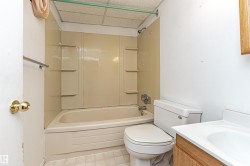 Full bath with  shower combination, vanity, and a drop ceiling - 