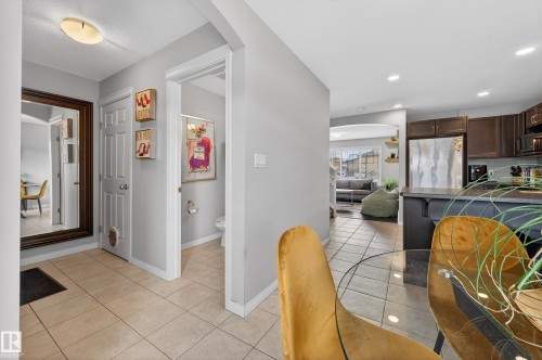 Dining room featuring arched walkways, light tile patterned floors, and recessed lighting - 5256 21 Avenue, Edmonton, AB - Indoor