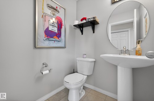 Bathroom featuring baseboards and light tile patterned floors - 5256 21 Avenue, Edmonton, AB - Indoor Photo Showing Bathroom