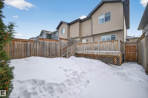 Snow covered property featuring a fenced backyard and a wooden deck - 5256 21 Avenue, Edmonton, AB - Outdoor With Deck Patio Veranda With Exterior