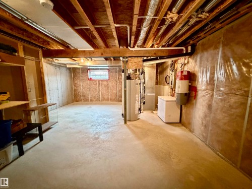 Basement featuring washer / clothes dryer and water heater - 5256 21 Avenue, Edmonton, AB - Indoor Photo Showing Basement